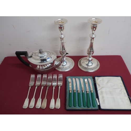 87 - Case set of butter knives, silver plated forks, silver plated teapot and a pair of plated candle sti... 