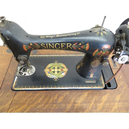 172 - Singer sewing machine and table with cast metal base and drawers to the side