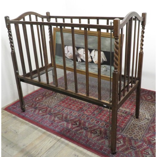 364 - 20th C Oak child's cot with barley twist decoration W61cm H110cm L120cm, and a humorous print of thr... 