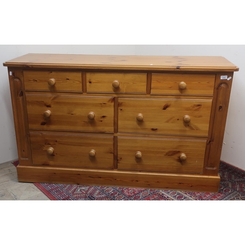 274 - Pine chest of three short and four deep drawers, with turned wooden handles, on plinth base