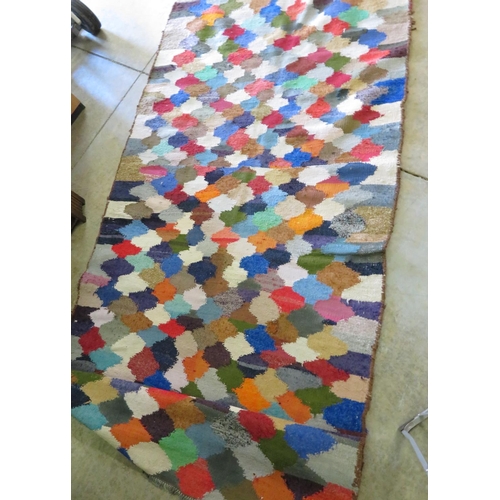 331 - Modern wool rug, all over decorated with a multi coloured lozenge design (300cm x 150cm)