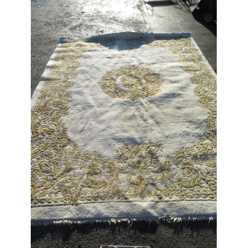 332 - Large wool carpet, with floral central medallion and spandrels on a cream ground (420cm x 300cm)