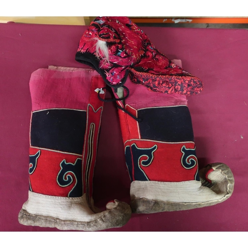 405 - Pair of 20th C Mongolian red cotton and felt boots, and a South East asian embroidered velvet hat de... 