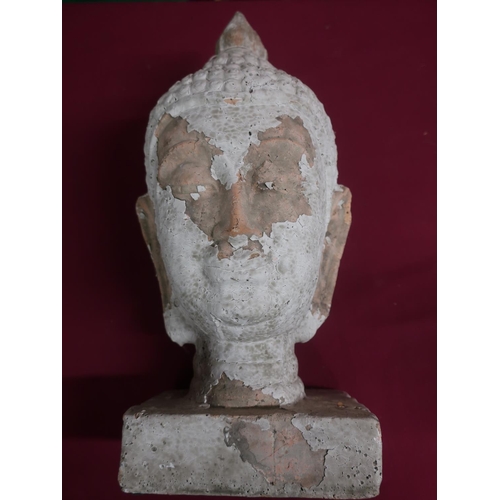 427 - Pottery model of a Tibetan deity head, with remnants of white finish, on a rectangular base, H43cm