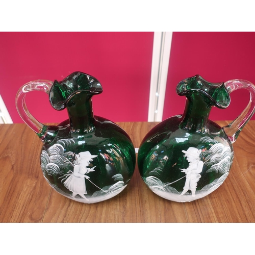 454 - Pair of green glass ewers, Mary Gregory style decorated with fishing figures, clear glass handles H5... 
