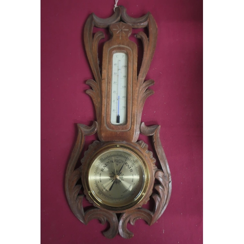 416 - 20th C aneroid barometer and thermometer in carved a pierced soft wood surround H40cm
