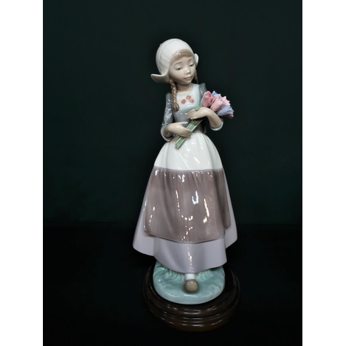 87 - Lladro figurine 5065 “Ingrid With Flowers” H25cm, including base.