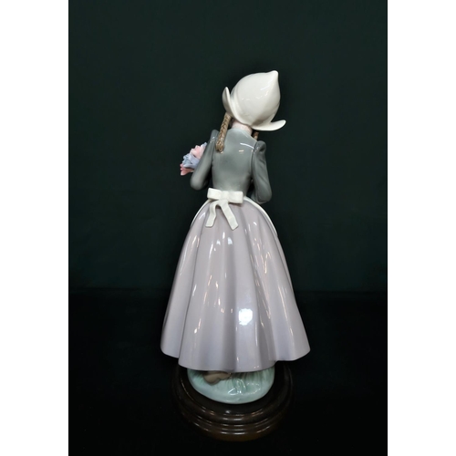 87 - Lladro figurine 5065 “Ingrid With Flowers” H25cm, including base.