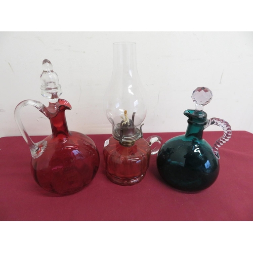 15 - Victorian Cranberry and clear glass moon shaped decanter with loop handle, a similar turquoise decan... 