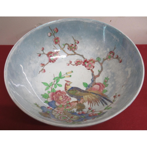 121 - Carlton Ware circular bowl decorated in colours in oriental style with an exotic bird on a prunus br... 