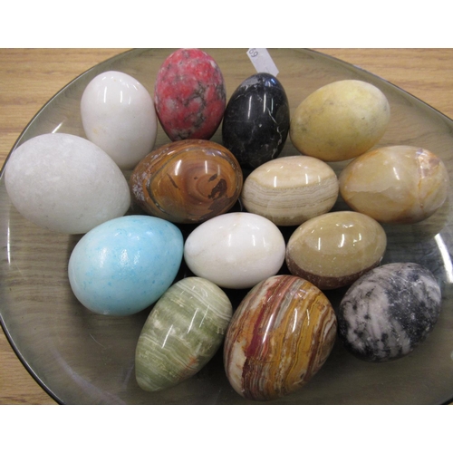 79 - 1970's Art glass bowl containing a collection of carved and polished hardstone eggs