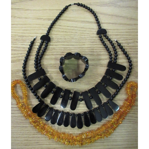 92 - Two late 19th C/early 20th C jet necklaces, jet bracelet and an amber necklace (4)