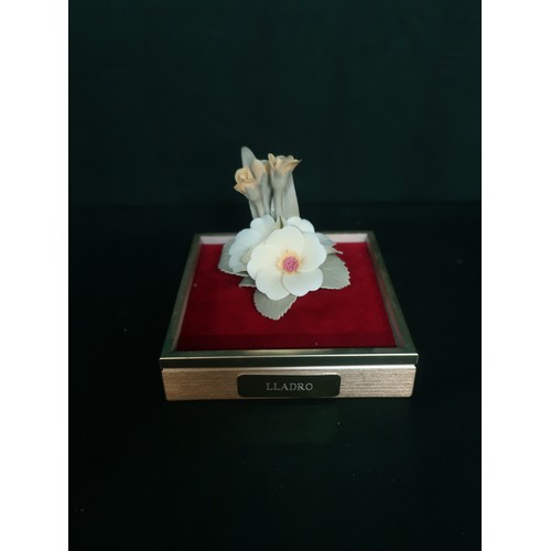 100A - Lladro decorative flower on a red velvet base with glass box top.