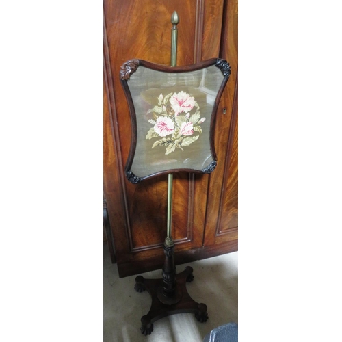 393 - William IV rosewood pole screen with shaped wool work banner on brass column, the shaped base on lob... 