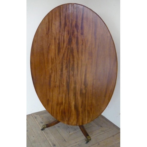 406 - Early 19th C mahogany oval breakfast table, tilt top on vase turned column with four out-splayed sup... 