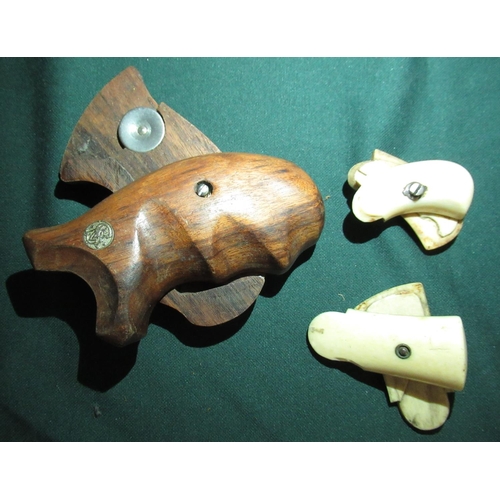 16 - Two pairs of 19th C ivory pistol grips 5.5cm and 5cm, and a pair of wooden Smith & Wesson pistol gri... 