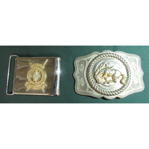 17 - Metal belt buckle with a bucking bronco and a belt buckle with the badge of the Kenyan Prisons Servi... 