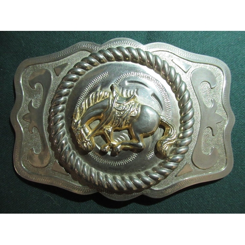 17 - Metal belt buckle with a bucking bronco and a belt buckle with the badge of the Kenyan Prisons Servi... 