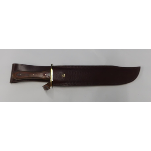 114 - Bowie type knife with 9 inch blade with brass cross piece and two piece wooden grip, made in Sheffie... 