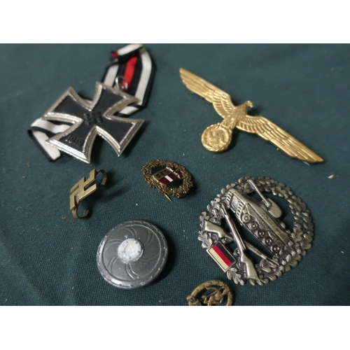 25 - Collection of German metal badges including Iron Cross, tank corp badge, eagle cap badge, etc (7)