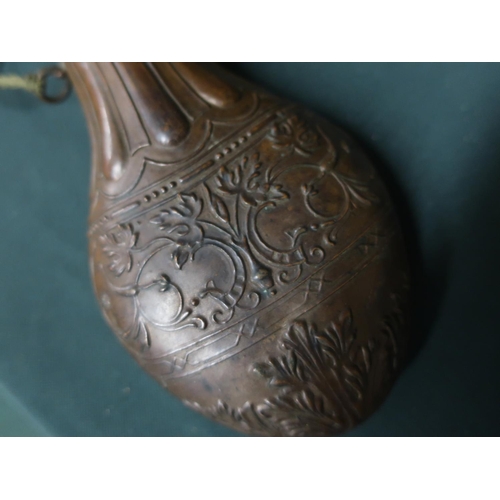 31 - Late 19th C copper ornately decorated powder flask and a late 19th C unnamed brass powder flask, two... 