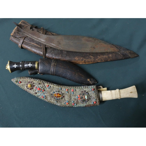 32 - Bone handled kukri with  ornate decoration to scabbard, small belt sized kukri, kukri blade and a ku... 