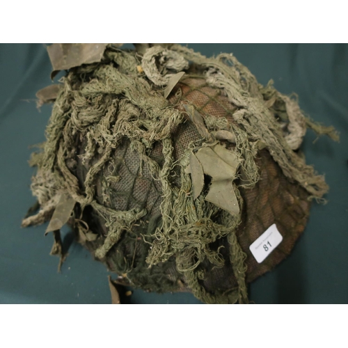 81 - Post WWII helmet with camouflaged netting and webbing