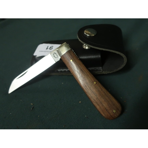 91 - Sheffield made single bladed pocket knife with polished wood grip and leather belt pouch