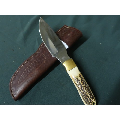 123 - Sheffield made sheath knife with four inch swollen blade, brass mounts and two piece Sambar horn gri... 