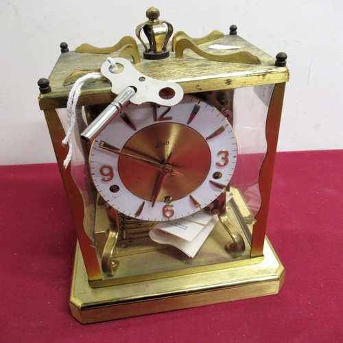 21 - Mid 20th C Schatz mantel clock, lacquered brass case  with four glazed panels on platform base, thre... 
