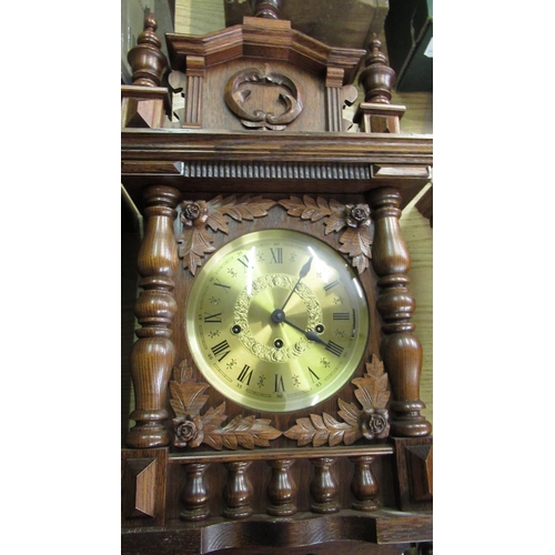 40 - Late 20th C wall clock, in carved oak case with turned finials and gallery, single glazed door enclo... 