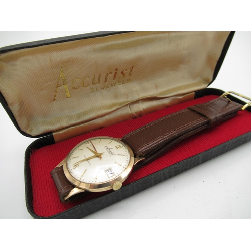 73 - Accurist gold hand wound wristwatch with date two piece case on leather strap, movement stamped Accu... 