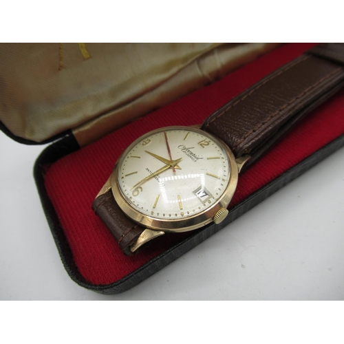 73 - Accurist gold hand wound wristwatch with date two piece case on leather strap, movement stamped Accu... 