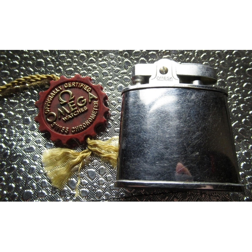 77 - 1950's Omega chrome plated cigarette lighter stamped on base, 1970's Omega watch tag (2)