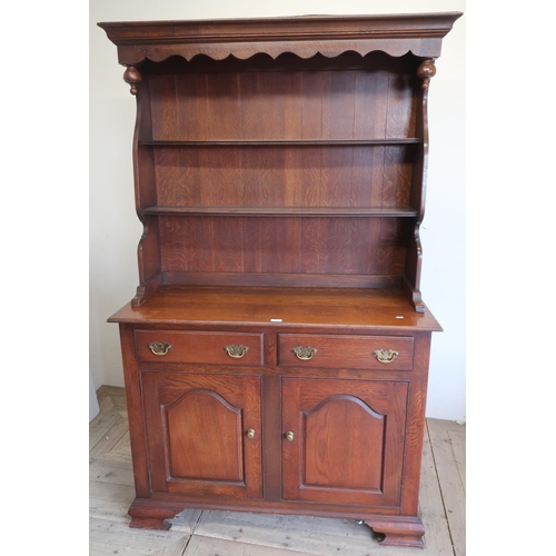 224 - George III oak style dresser, twin shelf back with shaped frieze above two drawers with arched panel... 