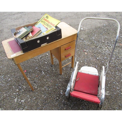 214 - Child's metal folding push chair with chrome mud guards, a child's desk and a quantity of card dolls... 