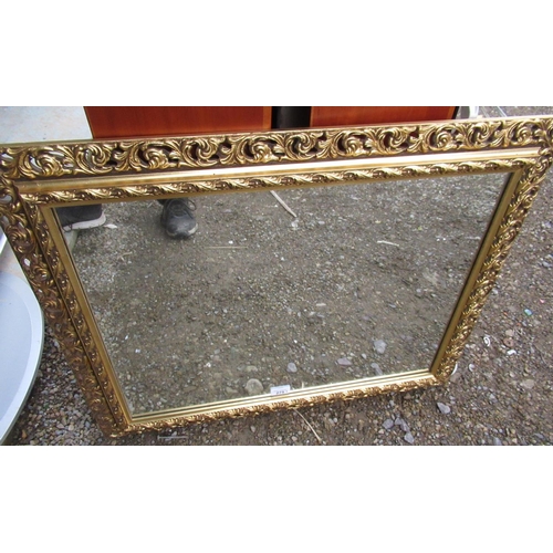 275 - Rectangular wall mirror in pierced and scrollwork gilt frame 59cm x 74cm