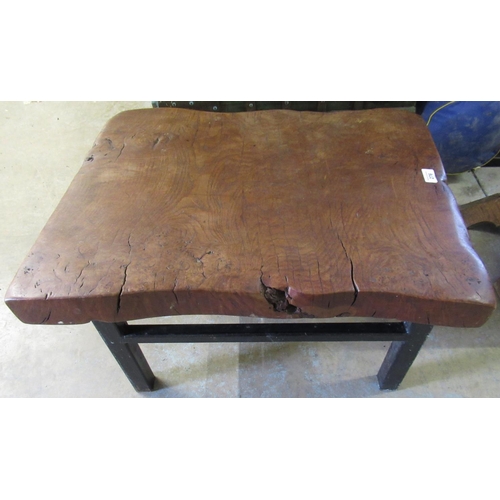 276 - Rustic made coffee table with thick solid burr wood top on wrought metal supports joined by stretche... 