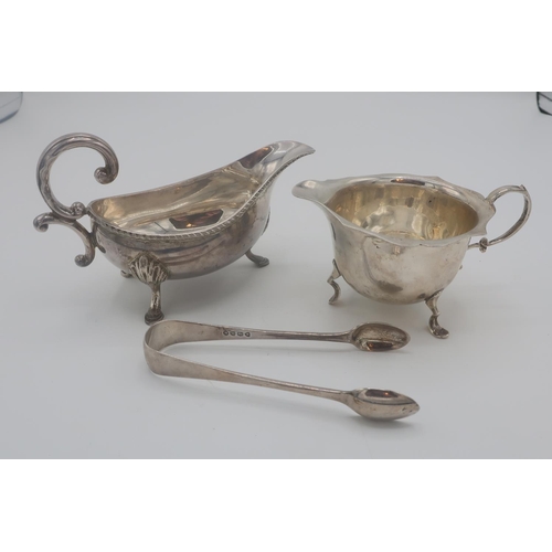 365 - Pair of Victorian silver hallmarked sugar tongs, London 1881, an Edw. VII cream jug, Birmingham 1904... 