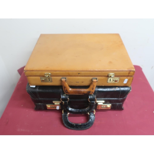 501 - Pig skin tan leather attaché case, and a black leather attaché case with combination locks
