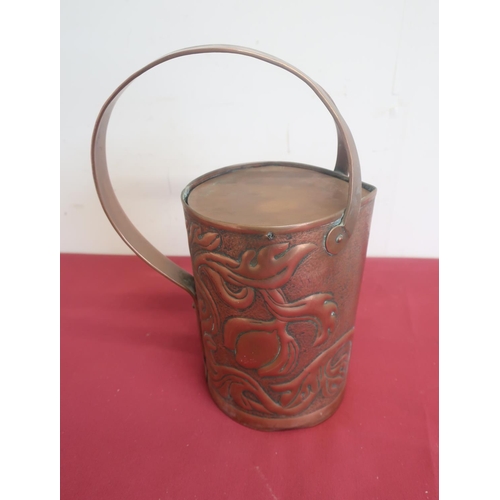 511 - Arts & Crafts copper jug stylised relief pomegranate decoration on a matted background, swing lid an... 