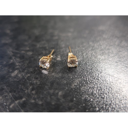 134 - Pair of single stone gold white stone ear studs stamped 375 and a similar single clip type earring, ... 