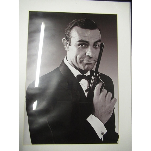 211 - Framed and mounted black & white photograph of Sean Connery as James Bond, 84cm x 64cm