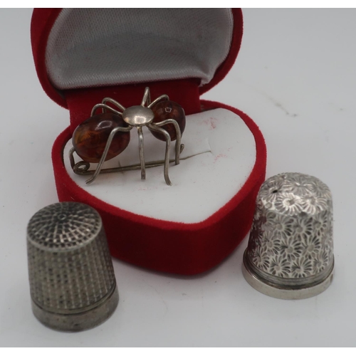 285 - Silver and amber spider brooch, silver hallmarked thimble and another thimble stamped Dorcas CH 7 (3... 