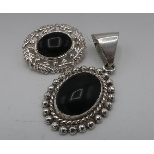 310 - Silver and Whitby Jet oval pendant and a similar oval brooch, both stamped 925 (2)