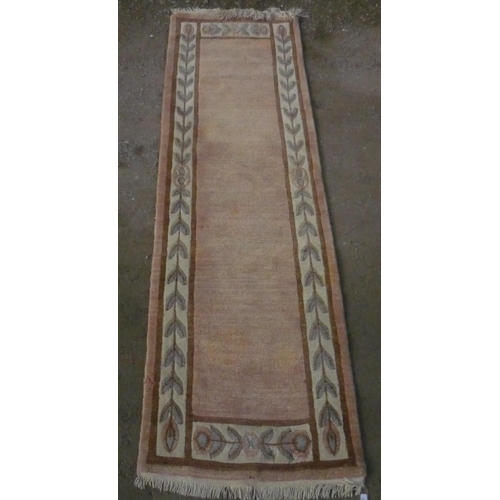 100 - 20th Century Nepalese wool runner, pink ground with stylized floral pattern border, W82cm L297cm