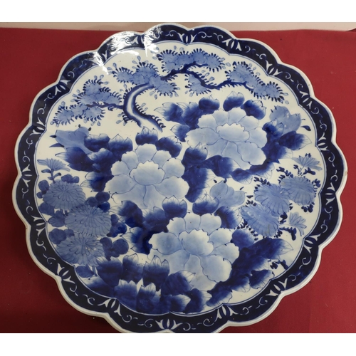 6 - Japanese waved edge circular blue and white charger, all over decorated with chrysanthemums, prunus ... 