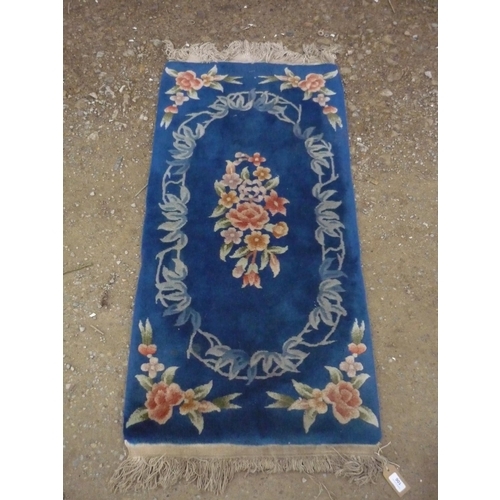 106 - Chinese embossed washed woolen rug, blue ground with central floral medallion and floral pattern spa... 