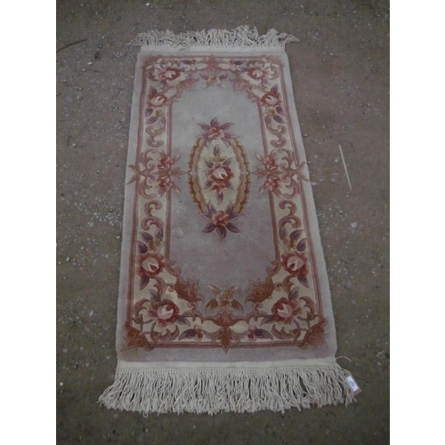 107 - Chinese washed woolen rug, beige ground with central floral pattern and floral patterned border, L14... 