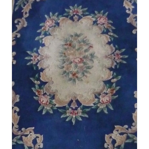 102 - Chinese embossed washed woolen rug, blue ground with central medallion and floral patterned border, ... 